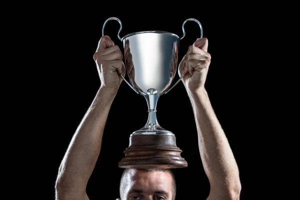 Successful rugby player holding trophy — Stock Photo, Image