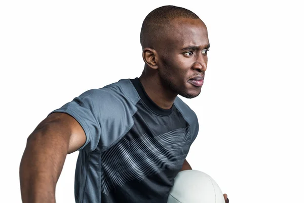 Спортсмен держит регбийный мяч — стоковое фото