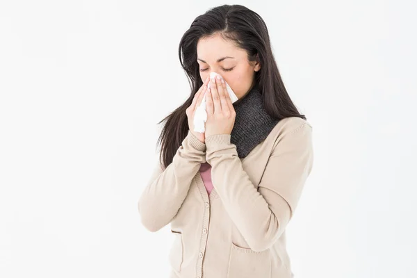 Sick brunette blowing her nose — Stock Photo, Image