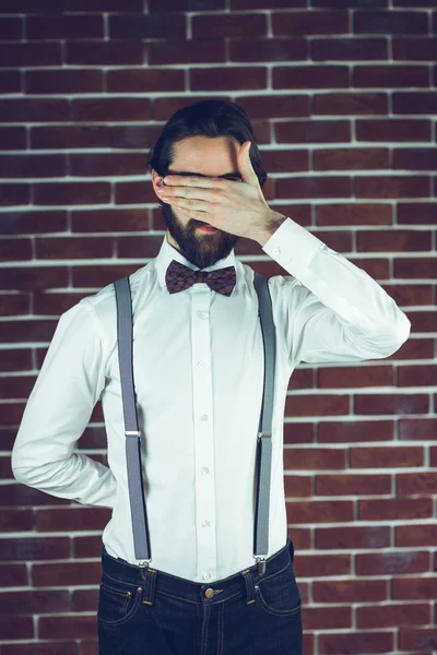 Serious man covering eyes — Stock Photo, Image