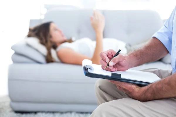 Terapeuta escribiendo en bloc de notas — Foto de Stock