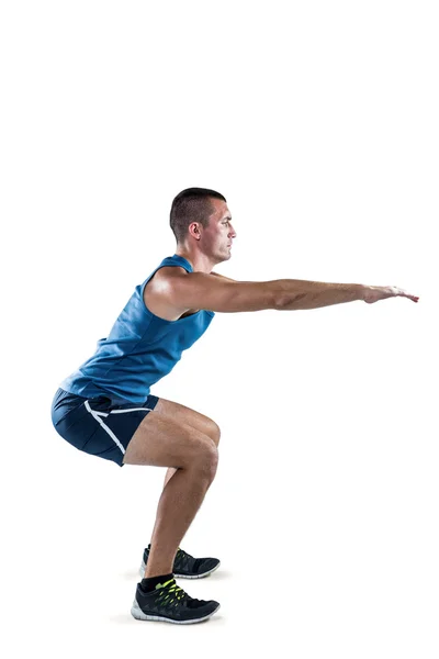 Fit man doing squats — Stock Photo, Image