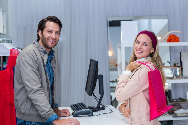 Smiling cashier and his customer — Stock Photo, Image