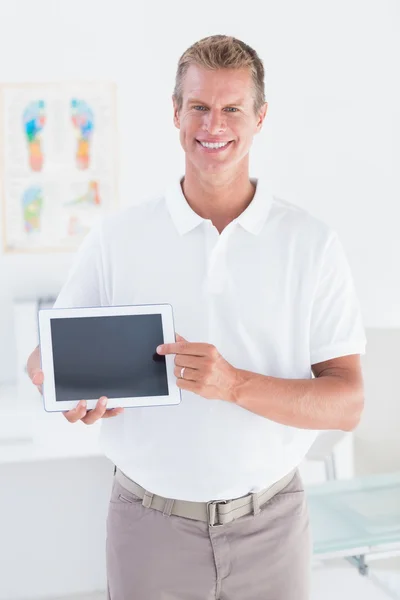 Médico sorridente mostrando tablet pc — Fotografia de Stock