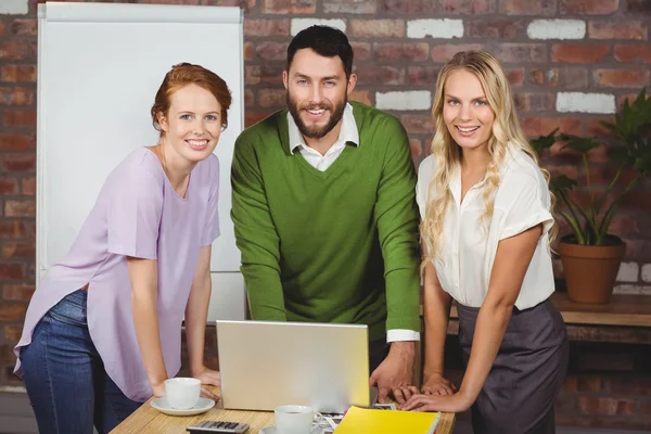 Business people leaning on desk — Stock Photo, Image