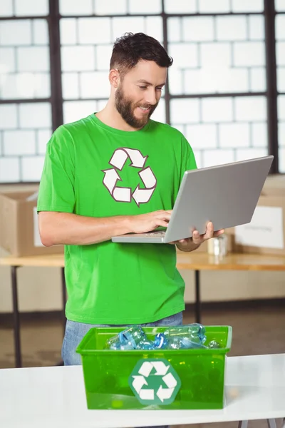 Happy volunteer using laptop — Stock Photo, Image