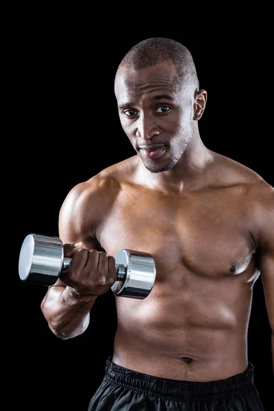 Athlete exercising with dumbbell — Stock Photo, Image