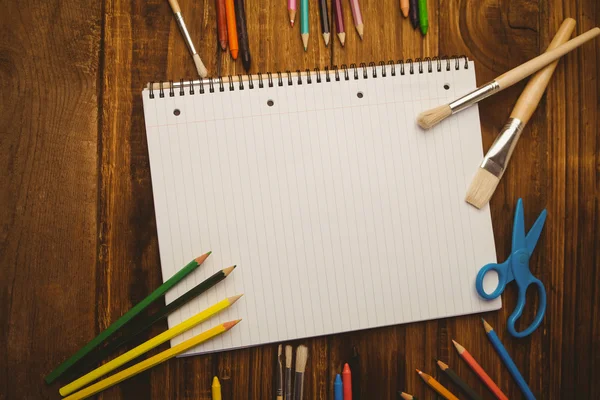 Notepad and art supplies on desk — Stock Photo, Image