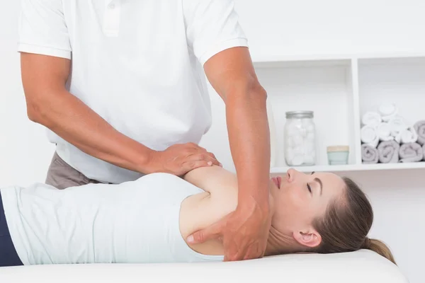 Doctor stretching woman back — Stock Photo, Image