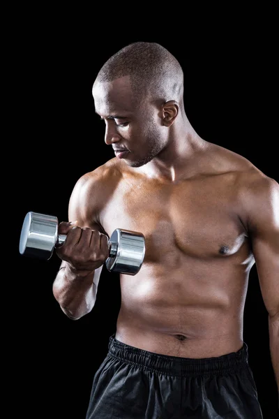 Athlete exercising with dumbbell — Stock Photo, Image