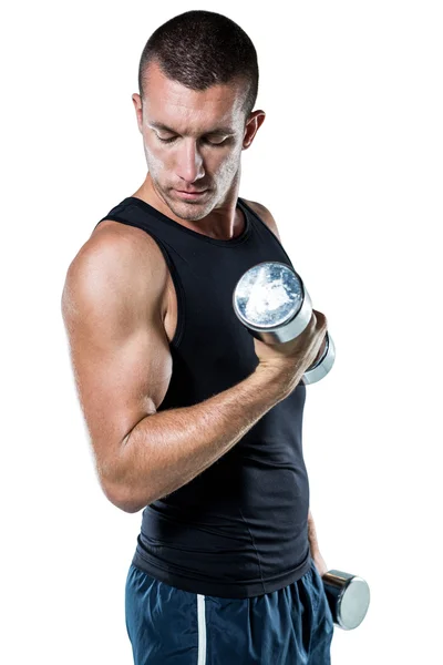 Confident athlete working out with dumbbells — Stock Photo, Image