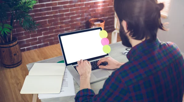 Creative businessman using laptop in office — Stock Photo, Image