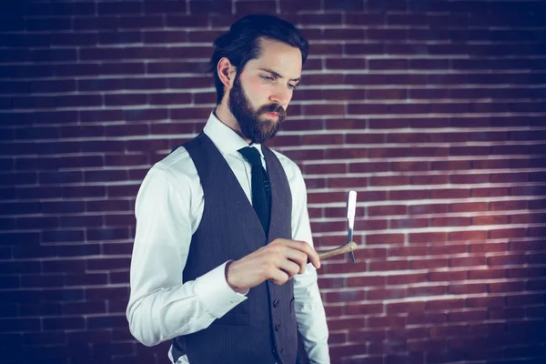 Serious man holding razor — Stock Photo, Image