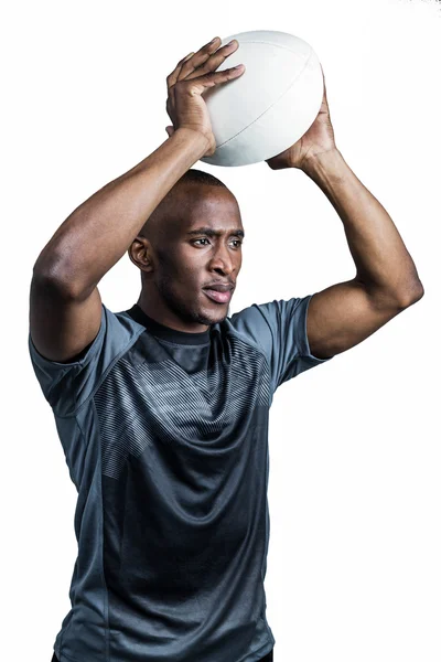 Confident sportsman throwing rugby ball — Stock Photo, Image