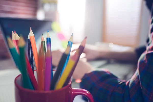 Colored pencils in mug with businessman — Stock Photo, Image