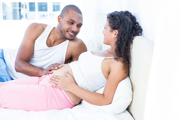 Husband lying with pregnant wife — Stock Photo, Image