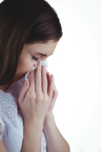 Sick brunette blowing her nose — Stock Photo, Image