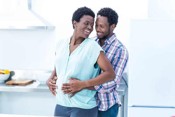 Man embracing his wife while standing — Stock Photo, Image