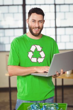 happy man using laptop in office clipart