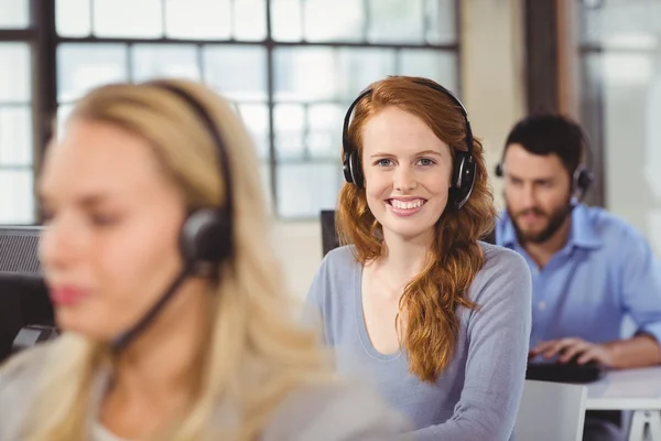 Smiling female operator in office — Stock Photo, Image