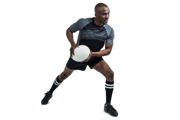Sportman in positie te gooien rugbybal — Stockfoto