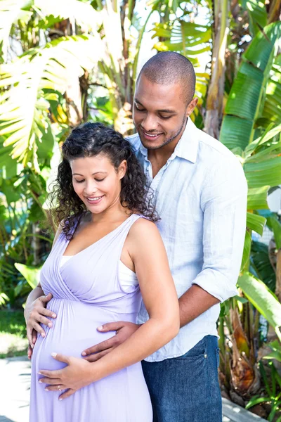 Husband touching pregnant wife belly — Stock Photo, Image