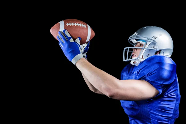 American football player looking at ball — Stock Photo, Image