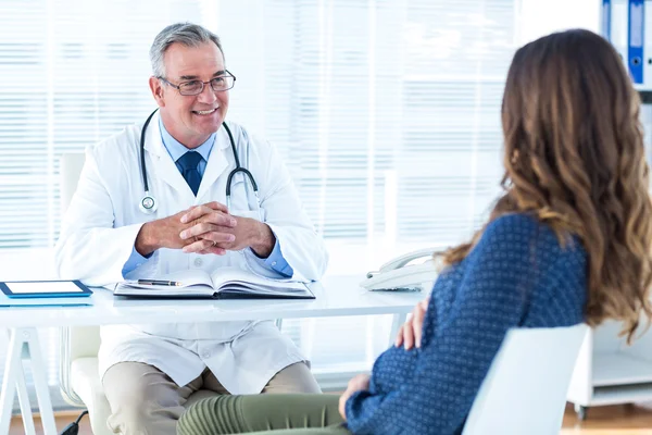 Doctor giving advise to pregnant woman — Stock Photo, Image