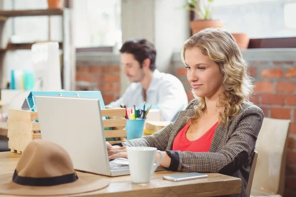 Businesswoman working on laptop in office — Stock Photo, Image