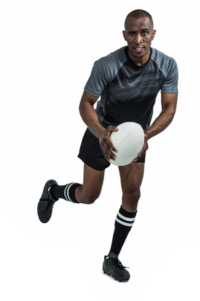 Determinado desportista correndo com bola de rugby — Fotografia de Stock