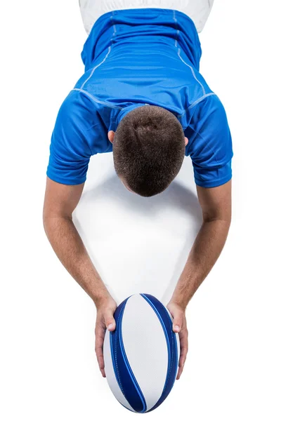 Rugby player lying with ball — Stock Photo, Image