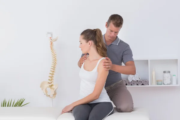 Doctor examining his patient neck — Stock Photo, Image