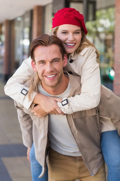 Girlfriend piggy-backing on boyfriend — Stock Photo, Image