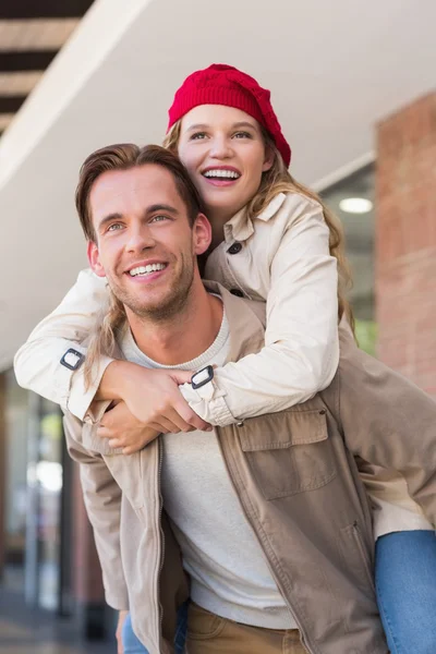 Girlfriend piggy-backing on her boyfriend — Stock Photo, Image