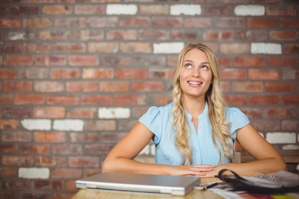 Thoughtful businesswoman in bright office — Stock Photo, Image