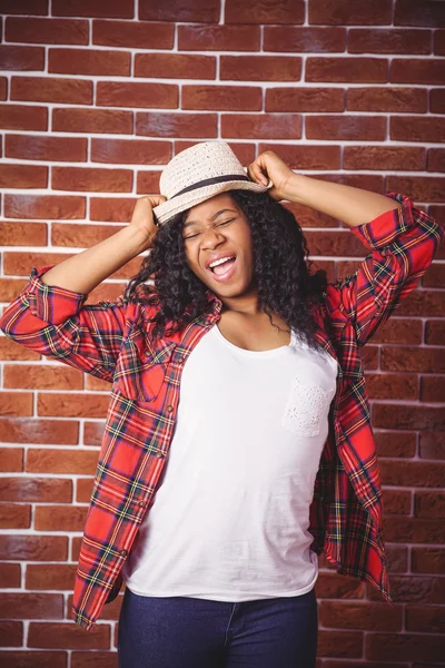 Hipster posing with a hat — Stock Photo, Image
