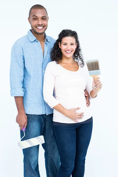 Couple with roller and paintbrush — Stock Photo, Image