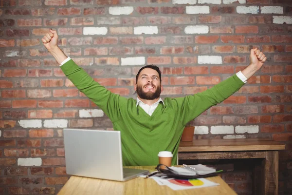 Businessman with arms raised in office — Stock Photo, Image