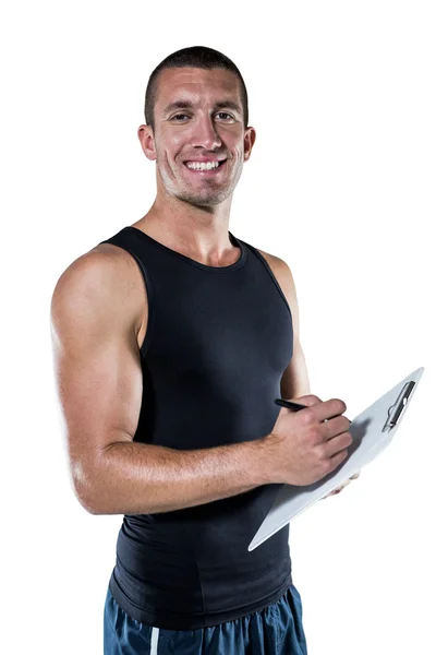 Sports coach writing on clipboard — Stock Photo, Image