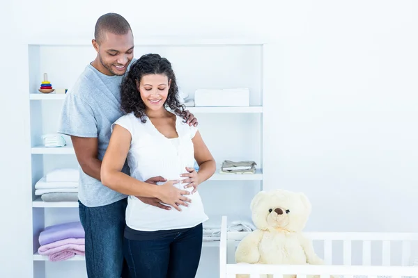 Husband touching pregnant wife belly — Stock Photo, Image