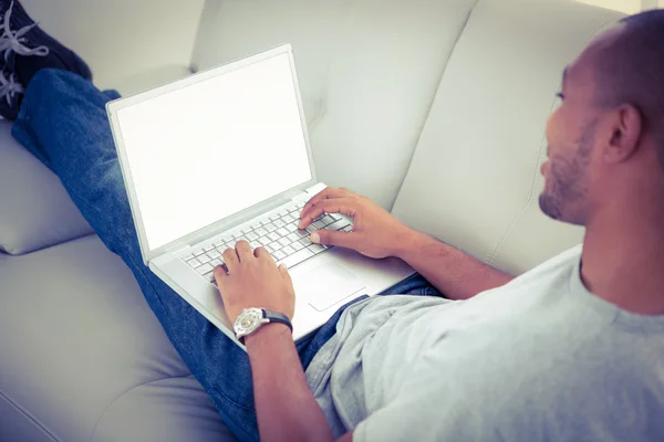 Людина за допомогою ноутбука розслабляється — стокове фото
