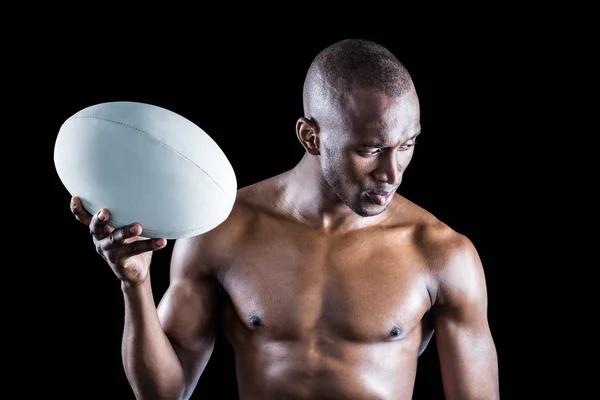 Sem camisa desportista segurando bola de rugby — Fotografia de Stock