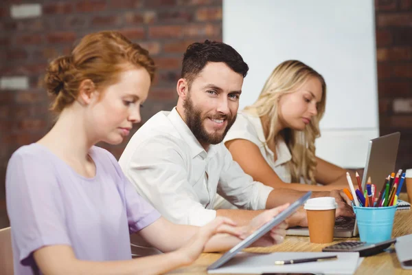 Man sitting amidst colleagues — Stock Photo, Image