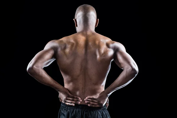 Idrottsman stretching med handen på höften — Stockfoto