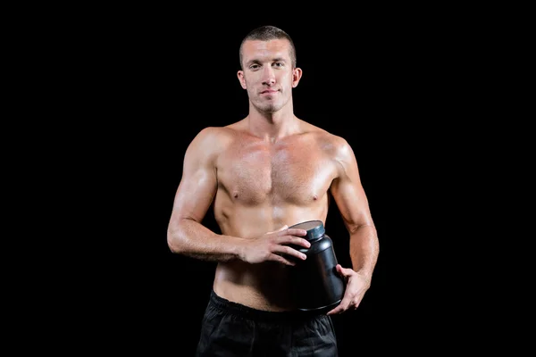 Homem sem camisa segurando suplemento nutricional — Fotografia de Stock