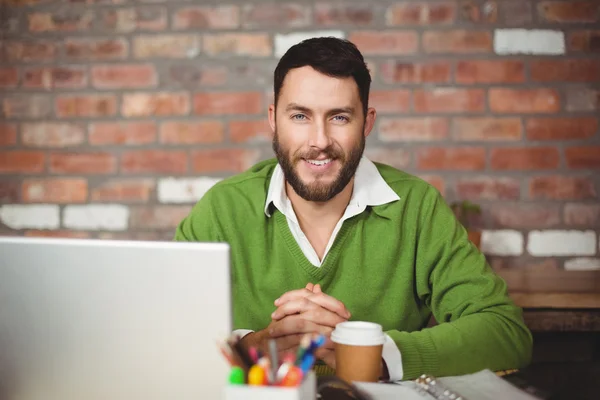 Homme souriant assis dans un bureau créatif — Photo