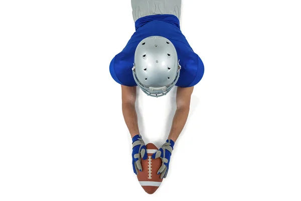 Football player reaching towards ball — Stock Photo, Image