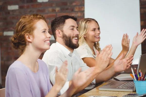 Felices colegas aplaudiendo en la reunión — Foto de Stock