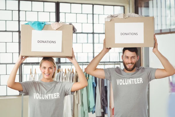 Volunteers carrying donation boxes — Stock Photo, Image