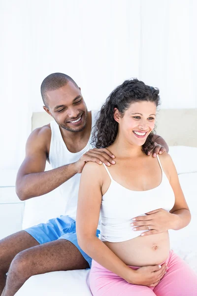 Husband massaging pregnant wife shoulders — Stock Photo, Image